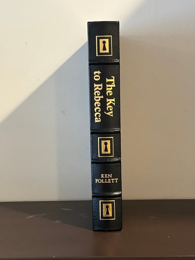 The Key To Rebecca by Ken Follett SIGNED Leather Bound Collector's Edition: The Key To Rebecca by Ken Follett SIGNED Leather Bound Collector's Edition published by The Easton Press, Norwalk, 1990. Dimensions: 11" x 9" x 2"