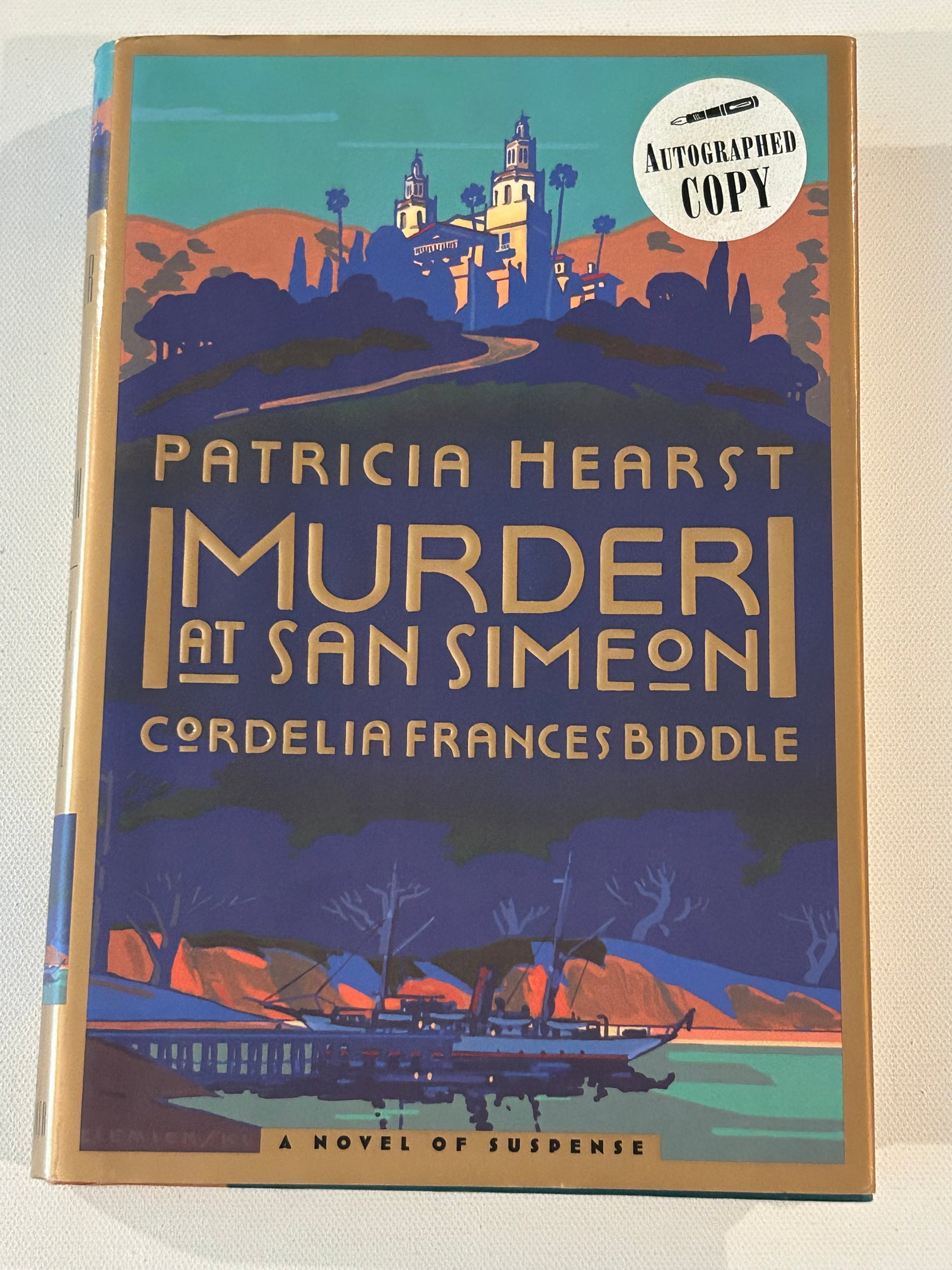 Murder At San Simeon by Patricia Hearst SIGNED First Edition: Murder At San Simeon by Patricia Hearst SIGNED First Edition published by Scribner, New York, 1996. Dimensions: 11" x 9" x 3"