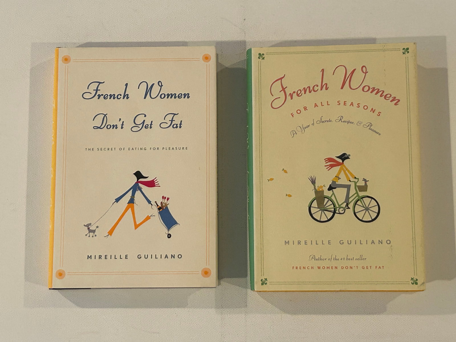 French Women Don't Get Fat & French Women For All Seasons by Mireille Guiliano SIGNED: French Women Don't Get Fat & French Women For All Seasons by Mireille Guiliano SIGNED First Editions published by Alfred A. Knopf, New York, 2005, 2006. Dimensions: 11" x 9" x 3"