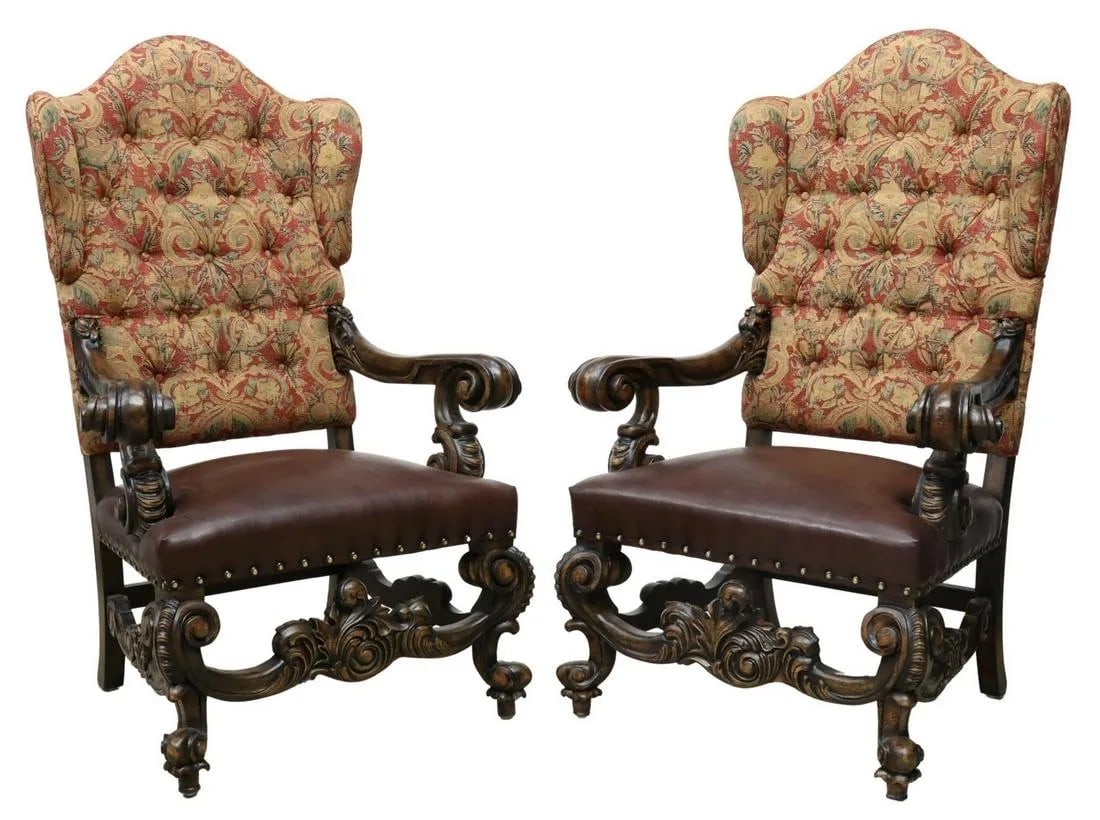 OVERSIZED BAROQUE STYLE WINGBACK ARMCHAIRS: (pair) Oversized Baroque style wingback armchairs, late 20th c., button-tufted back with small wings, substantial scrolled arms, brown leather seat with large tack trim, rising on cabriole legs,
