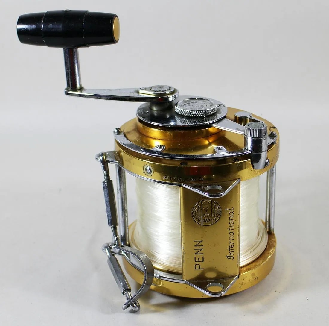 PENN INTERNATIONAL 80 BIG GAME FISHING REEL: A Penn International 80 gold series big game fishing reel. It is made is USA and is numbered NE0976.