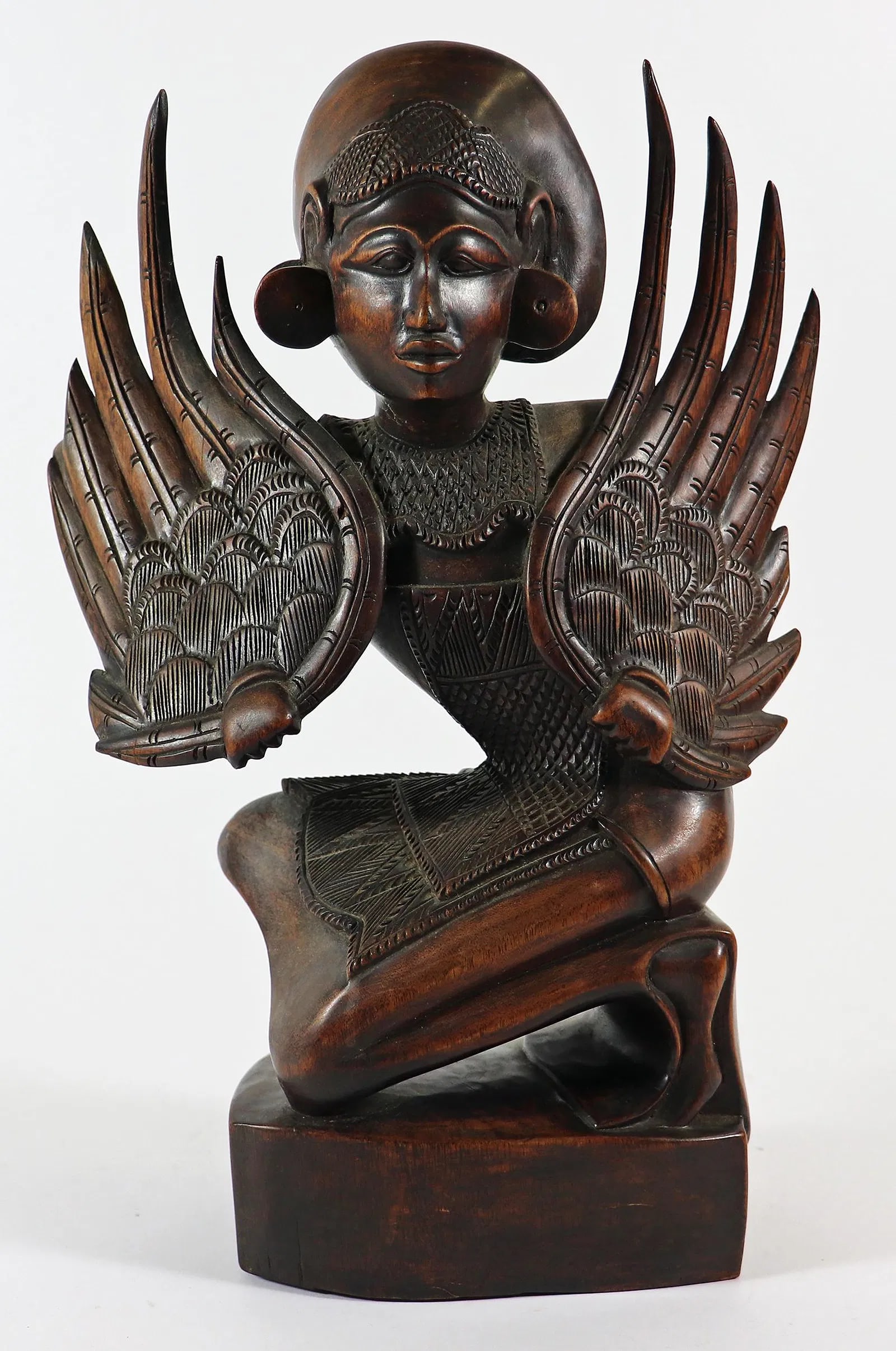 CARVED WOOD WINGED BALI LEGONG DANCER: A very detailed carved wood sculpture of a woman dancer holding angelic wings. Measures 13.5" x 9" x 3.5"