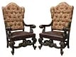 (2) OVERSIZED BAROQUE STYLE WINGBACK ARMCHAIRS: (pair) Oversized Baroque style wingback armchairs, late 20th c., button-tufted back with small wings, substantial scrolled arms, brown leather seat with large tack trim, rising on cabriole legs,