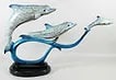 JAY WILLIAMS BRONZE DOLPHINS SCULPTURE: Jay Williams bronze sculpture of three swimming dolphins. Signed and numbered 39/50. Measures 24" long.