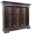 ITALIAN RENAISSANCE REVIVAL STAINED GLASS BOOKCASE: Italian Renaissance Revival bookcase, early 20th c., molded cornice and frieze, carved figural pilasters, turned column supports, three cabinet doors with stained and leaded glass panels, interior