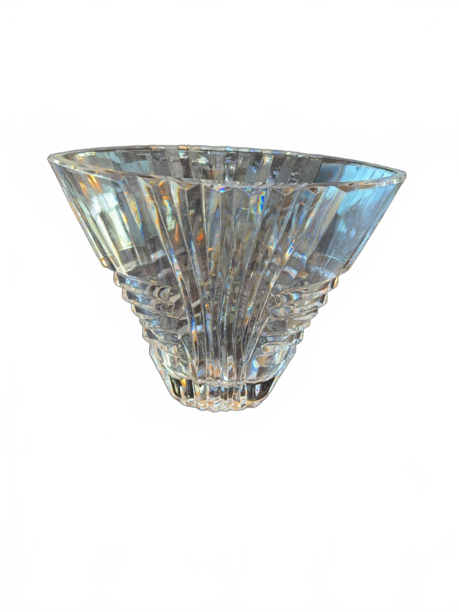Art Deco Style Cut Crystal Vase: Cut crystal vase featuring an angular, stepped Art Deco inspired design. The vase is clear and displays geometric facets, creating brilliant light reflections. It stands approximately 7 inches tall.