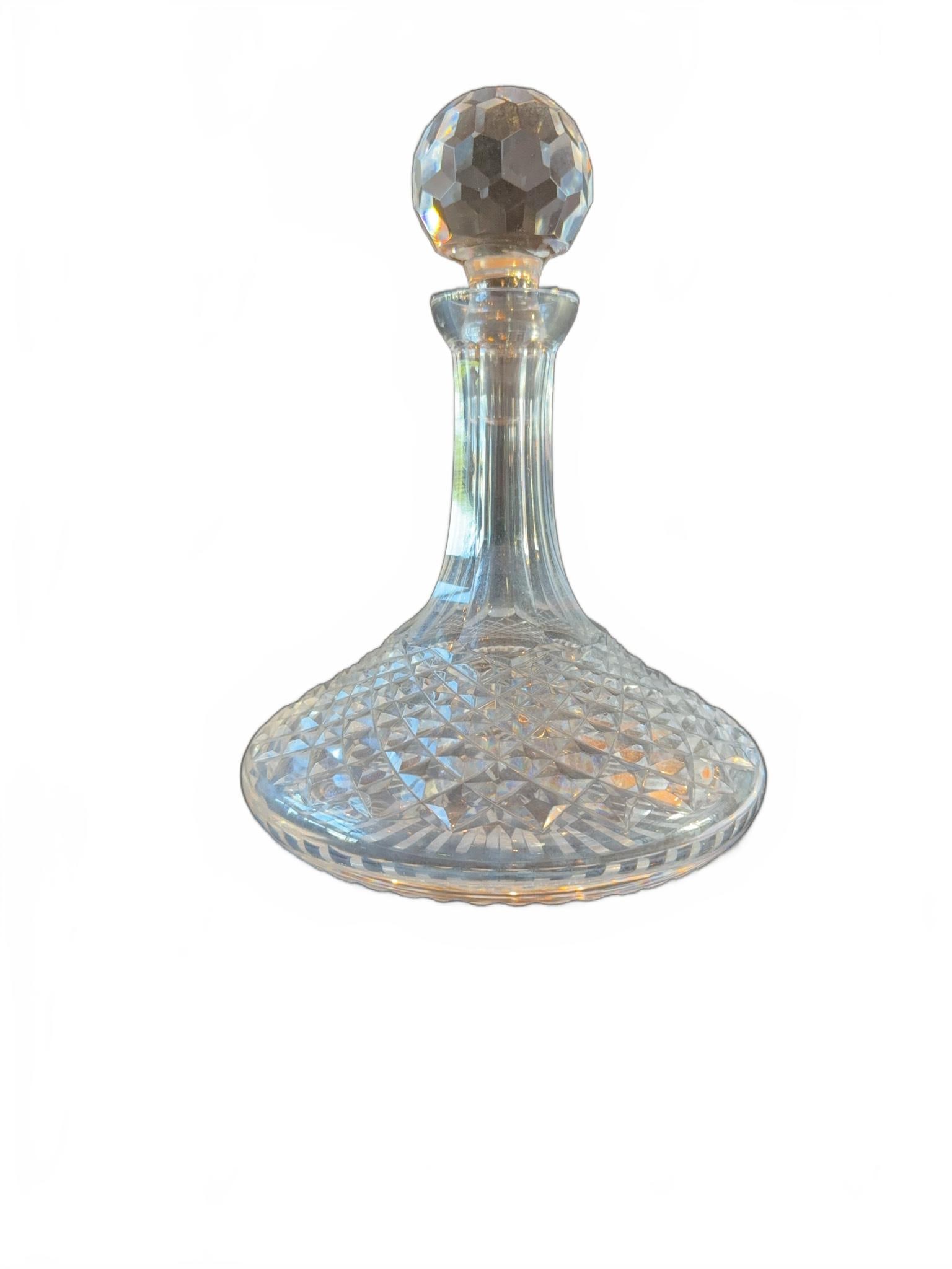 Cut Crystal Glass Ships Decanter with Stopper: Cut crystal glass decanter featuring a faceted spherical stopper and a broad base with intricate cross-hatch and star-cut patterns. The piece showcases fine craftsmanship and clear, reflective