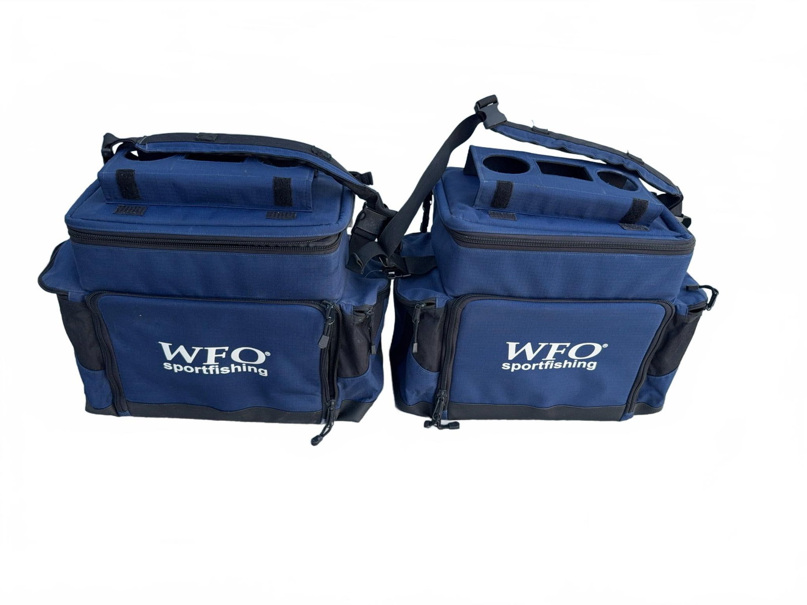 Pair WFO Sportfishing Tackle Bags: Two WFO Sportfishing tackle bags in blue with black trim. Each bag features a shoulder strap, multiple compartments with dividers, front and side zip pockets, and molded cup holders on top. Both bags