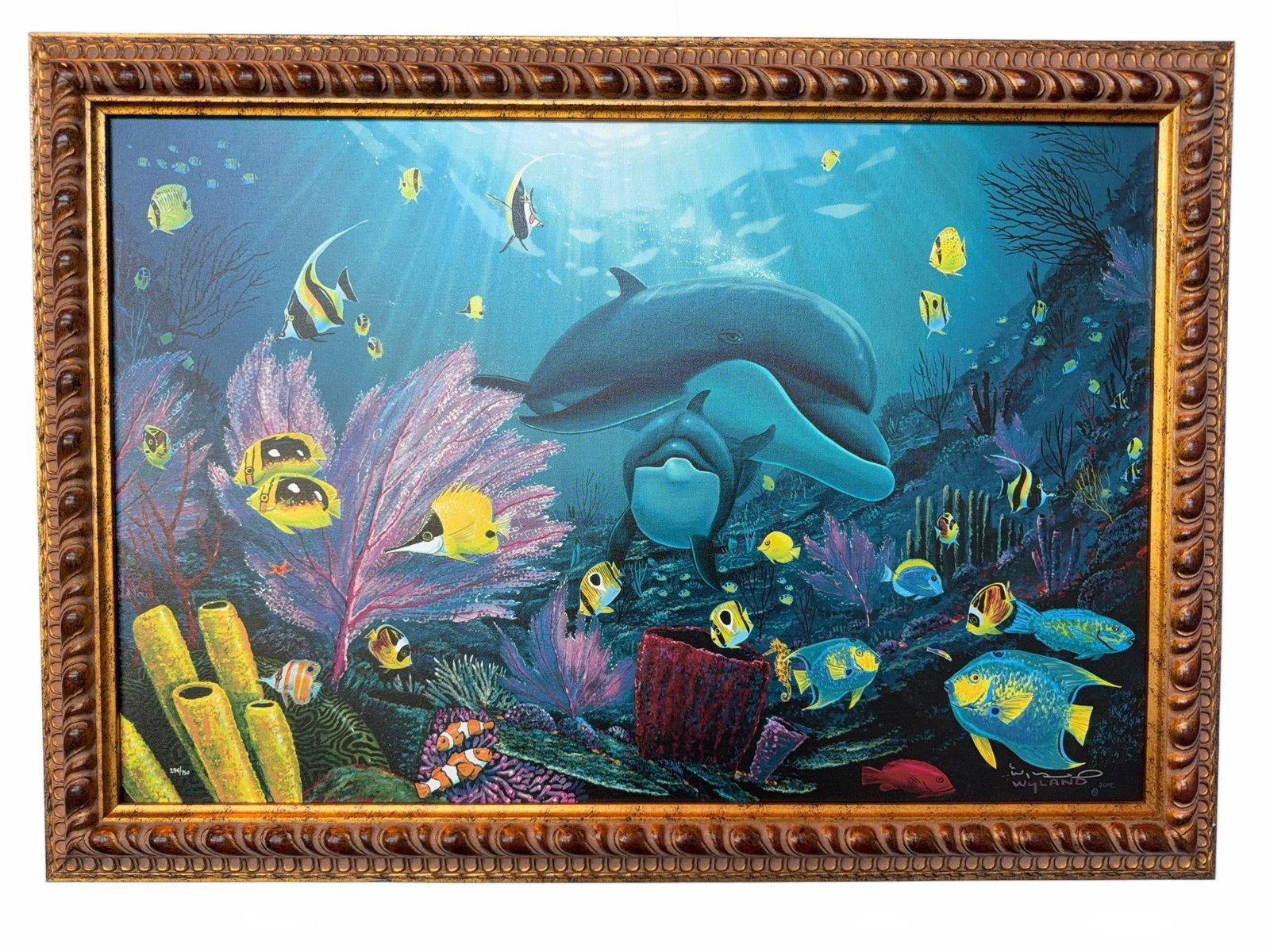 Wyland "Sea of Light" Limited Edition Framed Giclee: Limited edition giclee on canvas titled "Sea of Light" by Wyland, numbered and signed by the artist. Features a vibrant marine life scene with dolphins and tropical fish. Includes certificate of