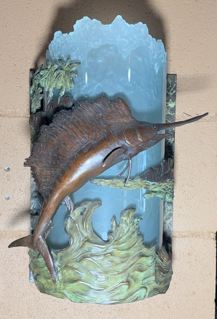 Brass Sailfish Wall Sconce With Glass Shade 1 of 2: Decorative wall sconce featuring a sailfish leaping from bronze-textured waves. The piece incorporates patinated bronze with detailed aquatic and scenic elements, and a textured frosted glass shade. S
