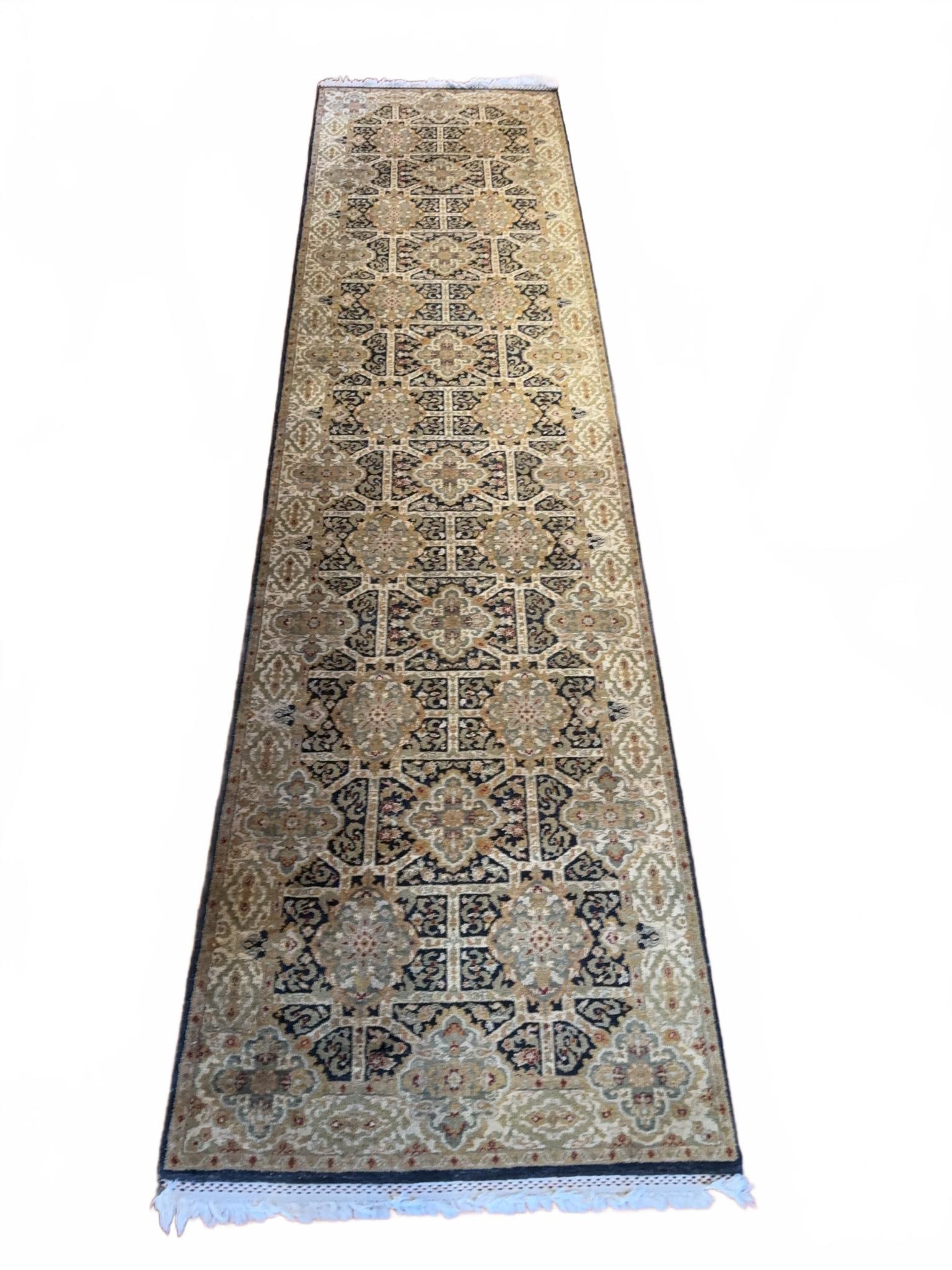 12' X 3' Hand-Knotted Oriental Runner Rug: Hand-knotted Persian style runner rug featuring traditional geometric and floral motifs in beige, green, navy, and gold tones. The rug is in good used condition with some minor visible wear to the fri