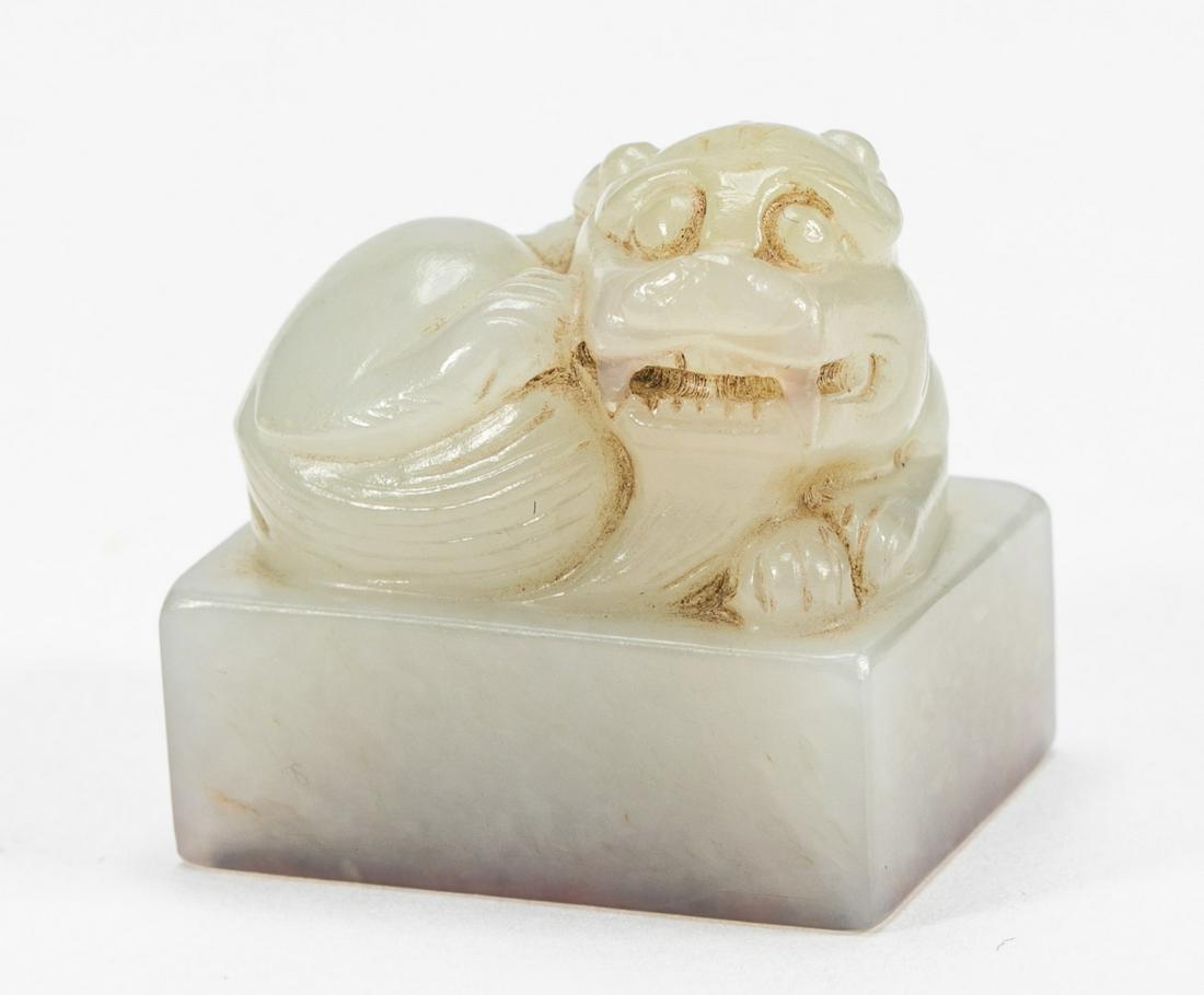 A PALE CELADON JADE FIGURE OF A FOODOG, QING DYNASTY (1 of 7)