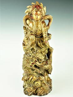 A ming dynasty gilt wood sculpture of guanyin riding on dragon: Additional Information: A magnificent wooden sculpture from the Ming Dynasty, featuring a gilded depiction of Guanyin riding on a dragon. This exquisite artwork showcases the exceptional craftsmanship