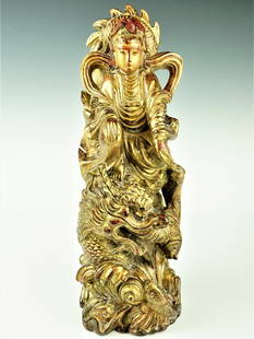 A ming dynasty gilt wood sculpture of guanyin riding on dragon: Additional Information: A magnificent wooden sculpture from the Ming Dynasty, featuring a gilded depiction of Guanyin riding on a dragon. This exquisite artwork showcases the exceptional