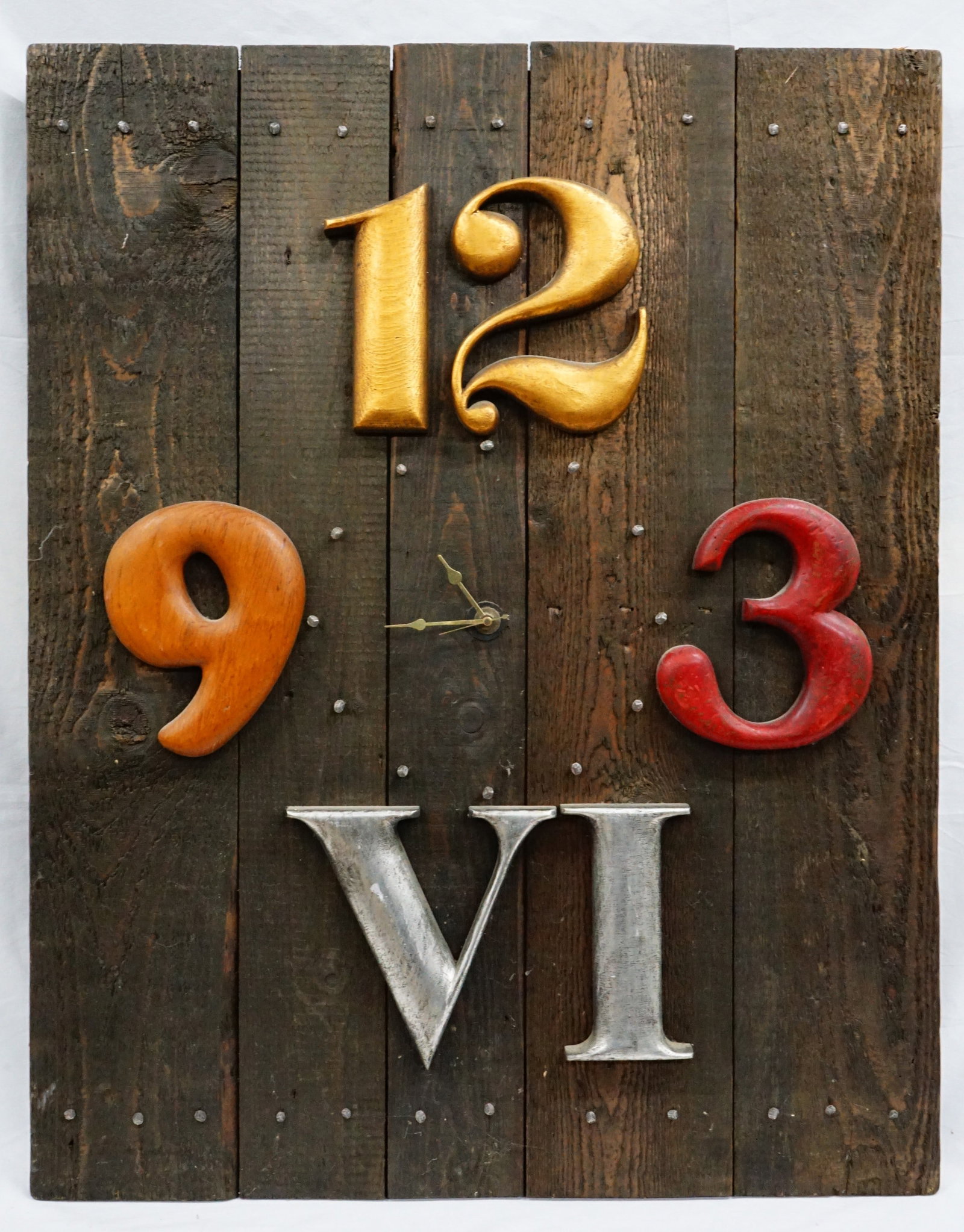 A wooden wall art piece featuring a clock with numerical and alphabetical markings (1 of 3)
