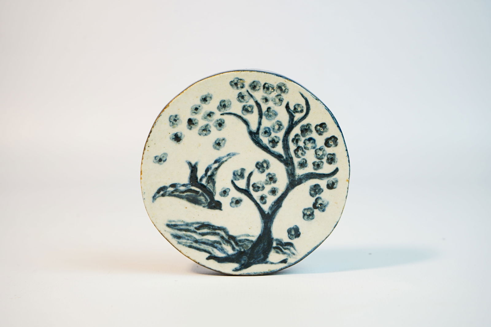 Handcrafted circular ceramic decorative piece with a tree pattern,20th c (1 of 4)