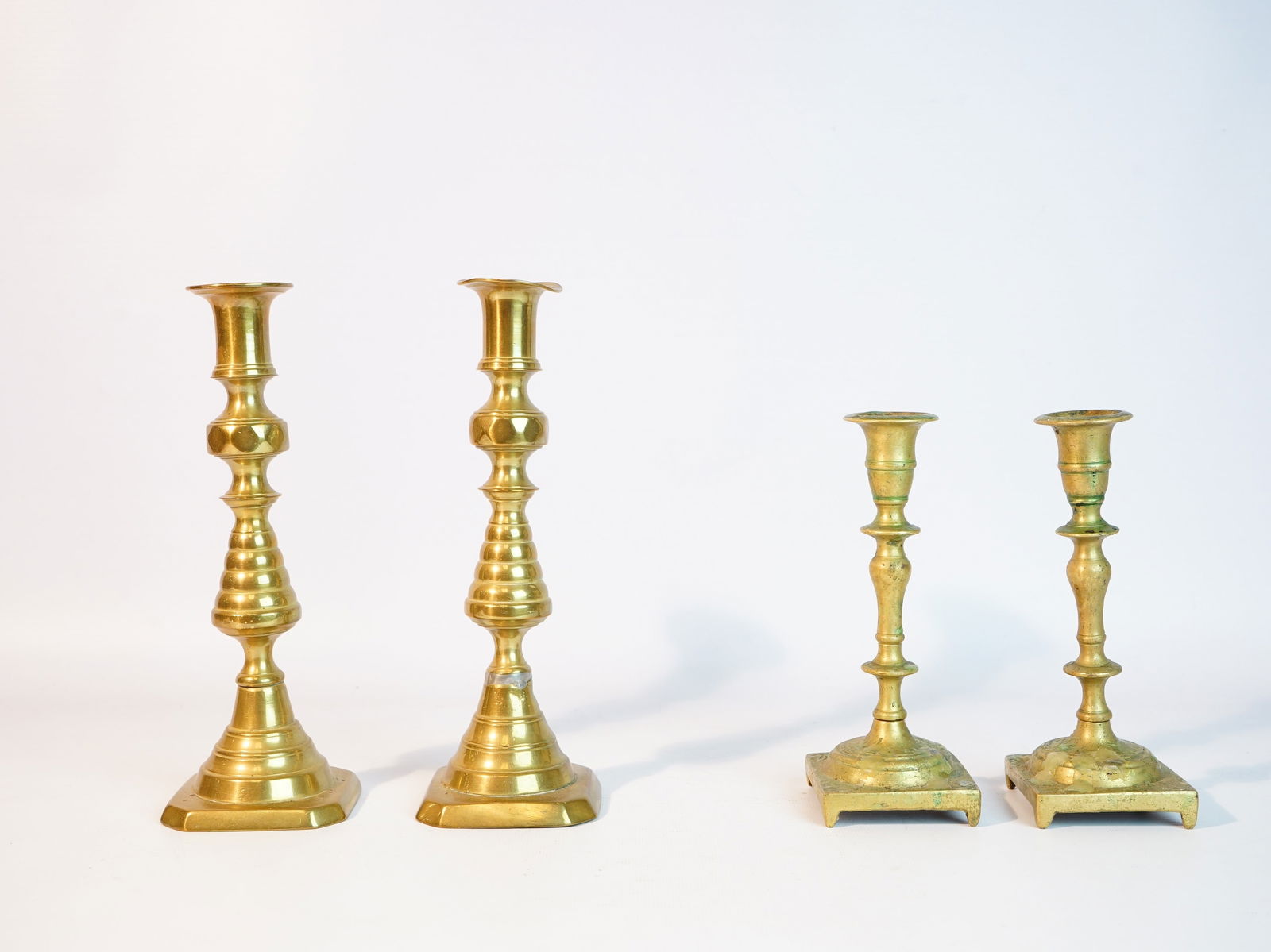 2 Pair of England Brass Candlesticks: Approximate size:H:9.75 in/6.75 in Shipping: We offer in-house shipping services for most small items. This means that we will take care of packing and shipping the items directly to you. For larger o