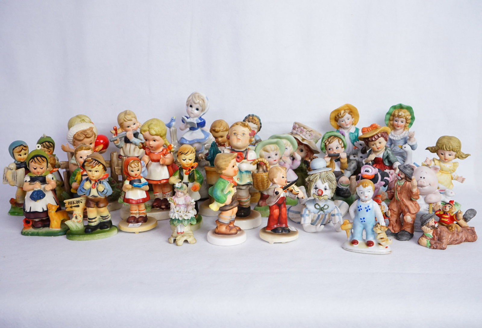 Group of Hummel Style Porcelain Figurines and Other: Shipping: We offer in-house shipping services for most small items. This means that we will take care of packing and shipping the items directly to you. For larger or specialized items, we recommend u