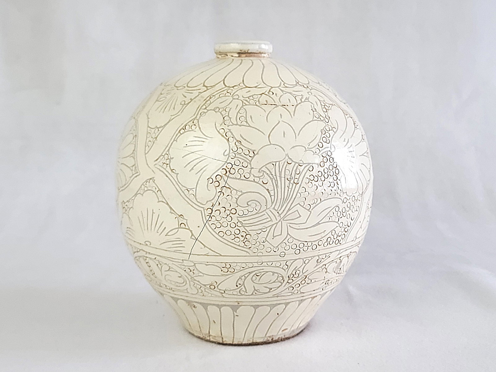 A Engraved White-Glazed Cizhou Stoneware Vase: Approximate size: 9x7.5x7.5 in Shipping: We offer in-house shipping services for most small items. This means that we will take care of packing and shipping the items directly to you. For larger or sp