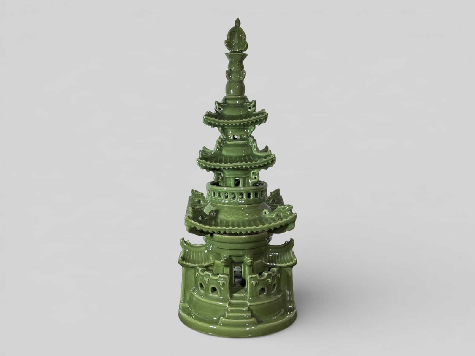 Japanese Celadon Porcelain Pagoda: Japanese celadon glazed porcelain model of a pagoda, fired in four section and stacked in layers. Signed with artist at bottom, 20"ht Shipping: We offer in-house shipping services for most small items