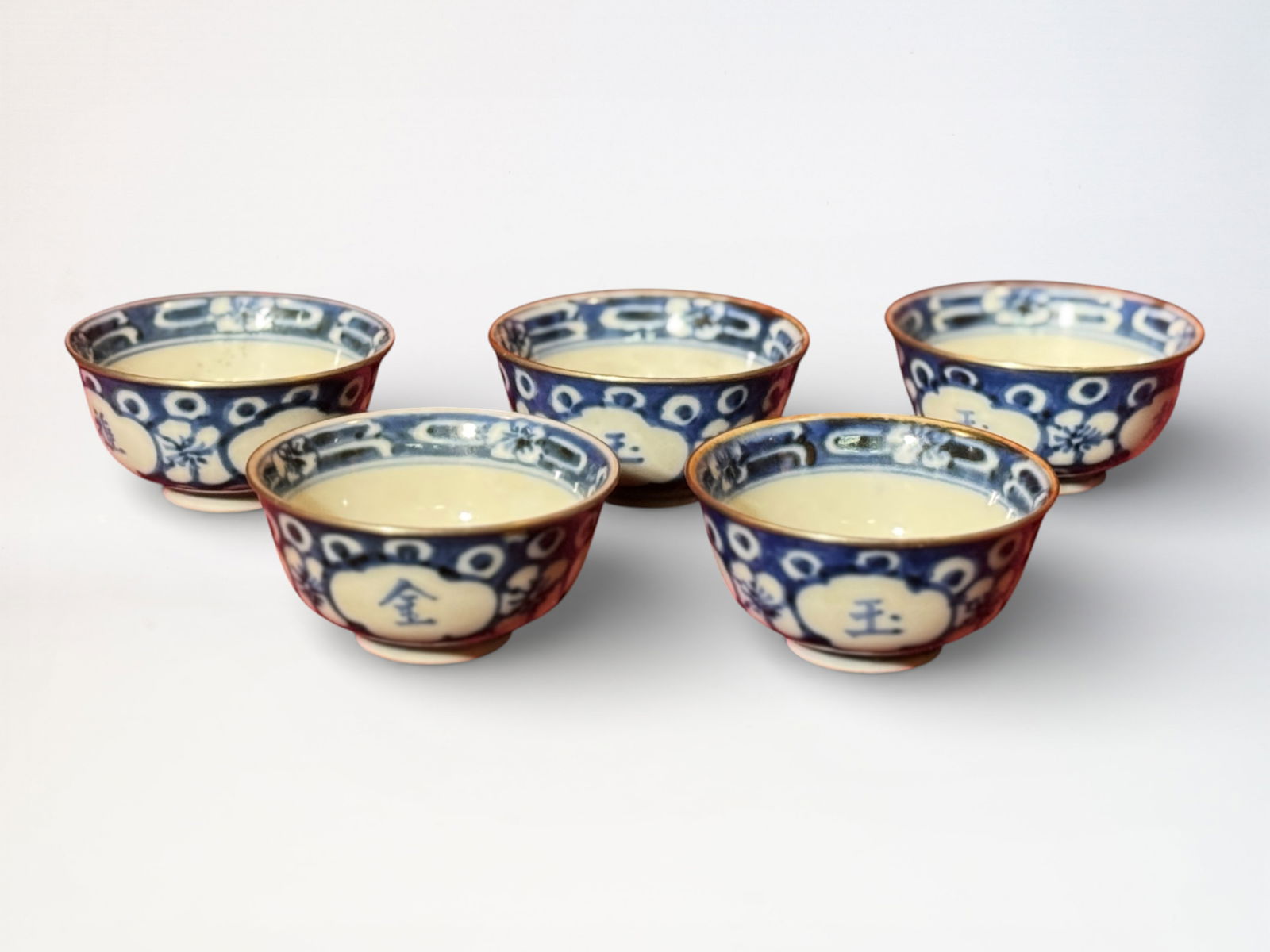 Set of Five Chinese Blue and White Porcelain Teacups: Set of five chinese blue white porcelain teacups with silver rim, one cup has small rim flake as seen in photo, 3.3"dia 1.75"ht, ming mark at bottom Shipping: We offer in-house shipping services for m