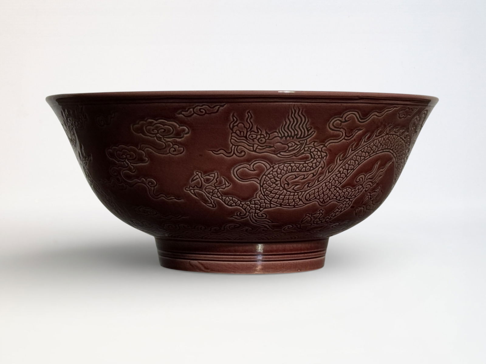 Chinese Incised Red Glazed ‘Dragon’ Bowl: Chinese porcelain bowl with incised dragon motif, 7.25"dia 3.15"ht Shipping: We offer in-house shipping services for most small items. This means that we will take care of packing and shipping the ite