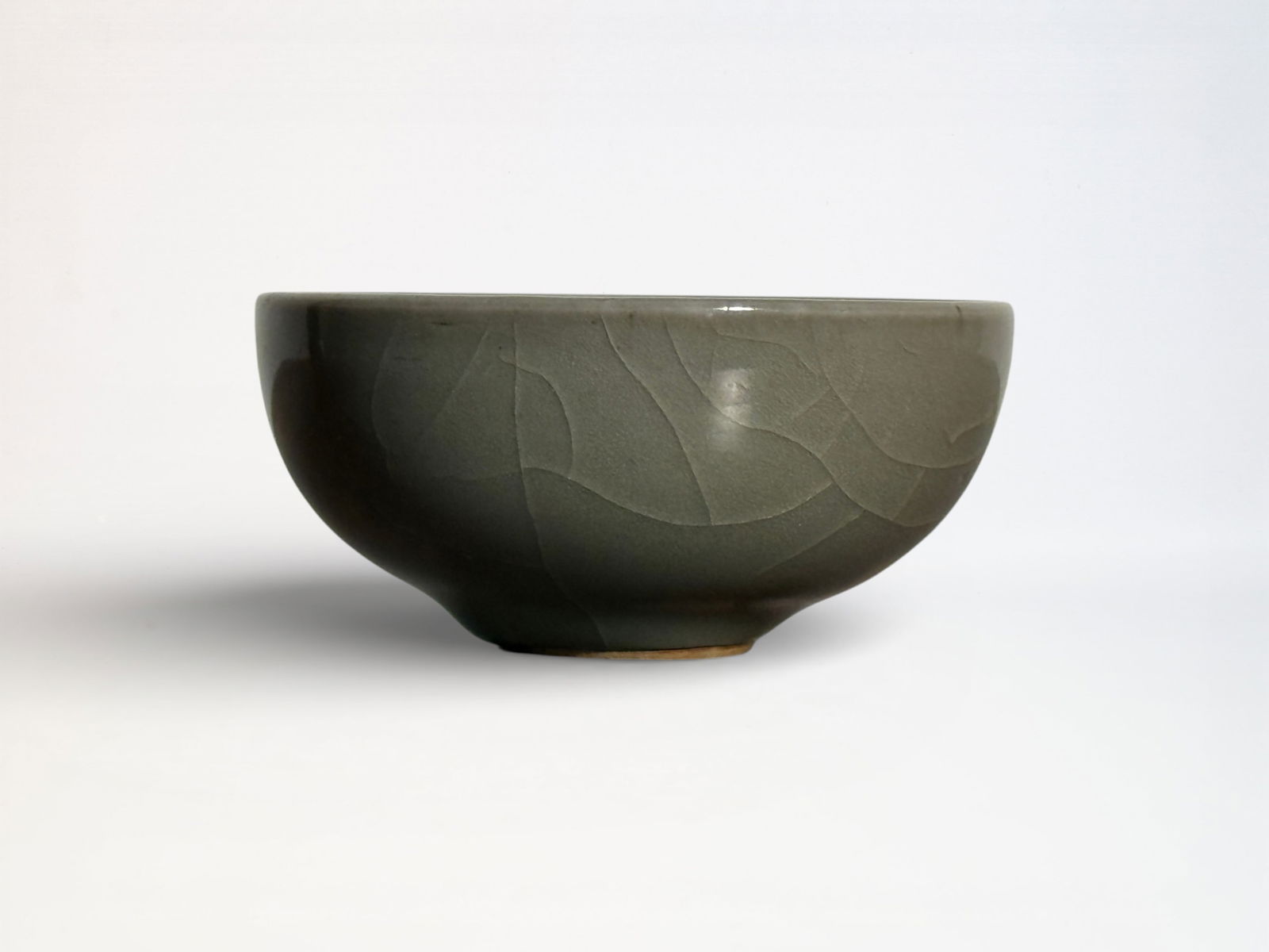 Chinese Celadon Porcelain Wine Cup: Chinese celadon glazed porcelain winecup with rasied flower in the interior center, unmarked, 3.5"dia 1.5"ht Shipping: We offer in-house shipping services for most small items. This means that we will