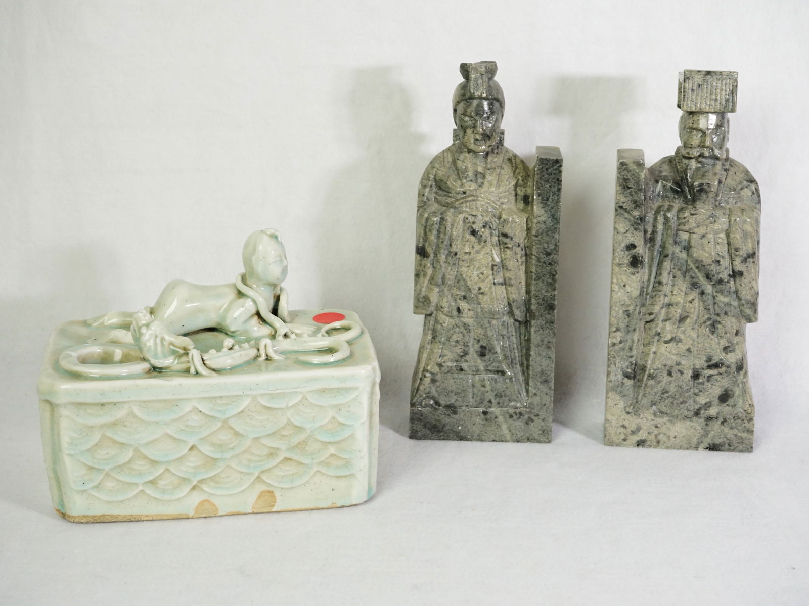 Group of Three Chinese Carvings,Including Celadon Glazed Brushwasher and Stone Figures Bookend: Approximate size:bookend H:9 in,porcelain 5.5x7x4.5 in Shipping: We offer in-house shipping services for most small items. This means that we will take care of packing and shipping the items