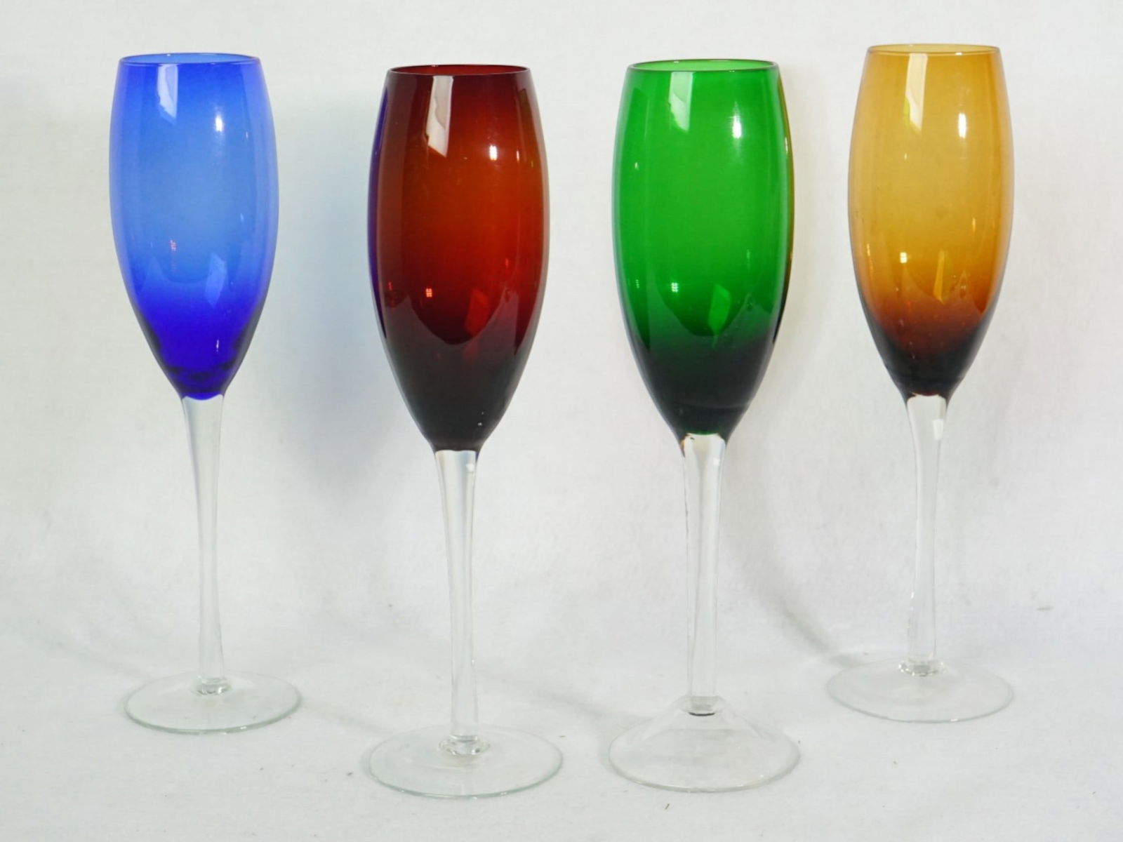 Set of Four Colored Glass Champagne Flutes: Approximate size:H:9.25 in Shipping: We offer in-house shipping services for most small items. This means that we will take care of packing and shipping the items directly to you. For larger or