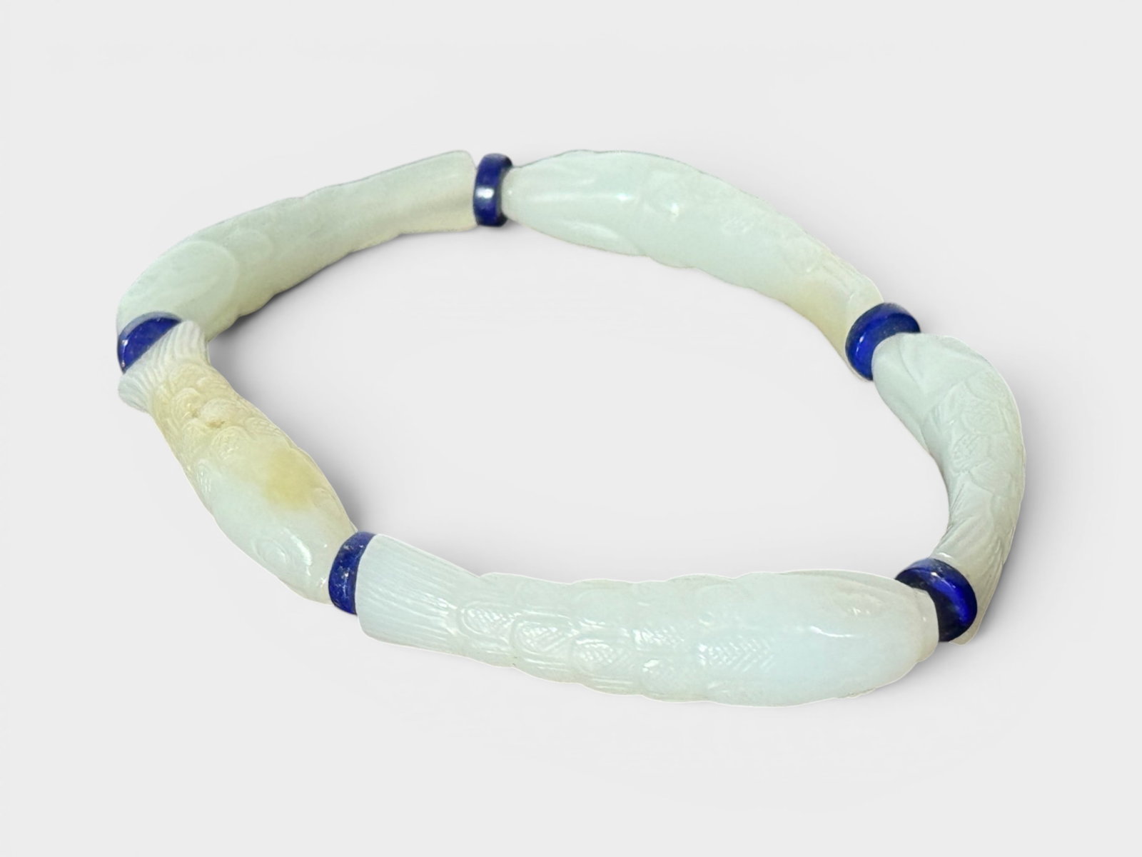 Chinese White Jade Bracelet of Fish Design: Chinese white jade bracelet of fish design, each fish 1.2"L, five fish put into a bracelet Shipping: We offer in-house shipping services for most small items. This means that we will take care of pack