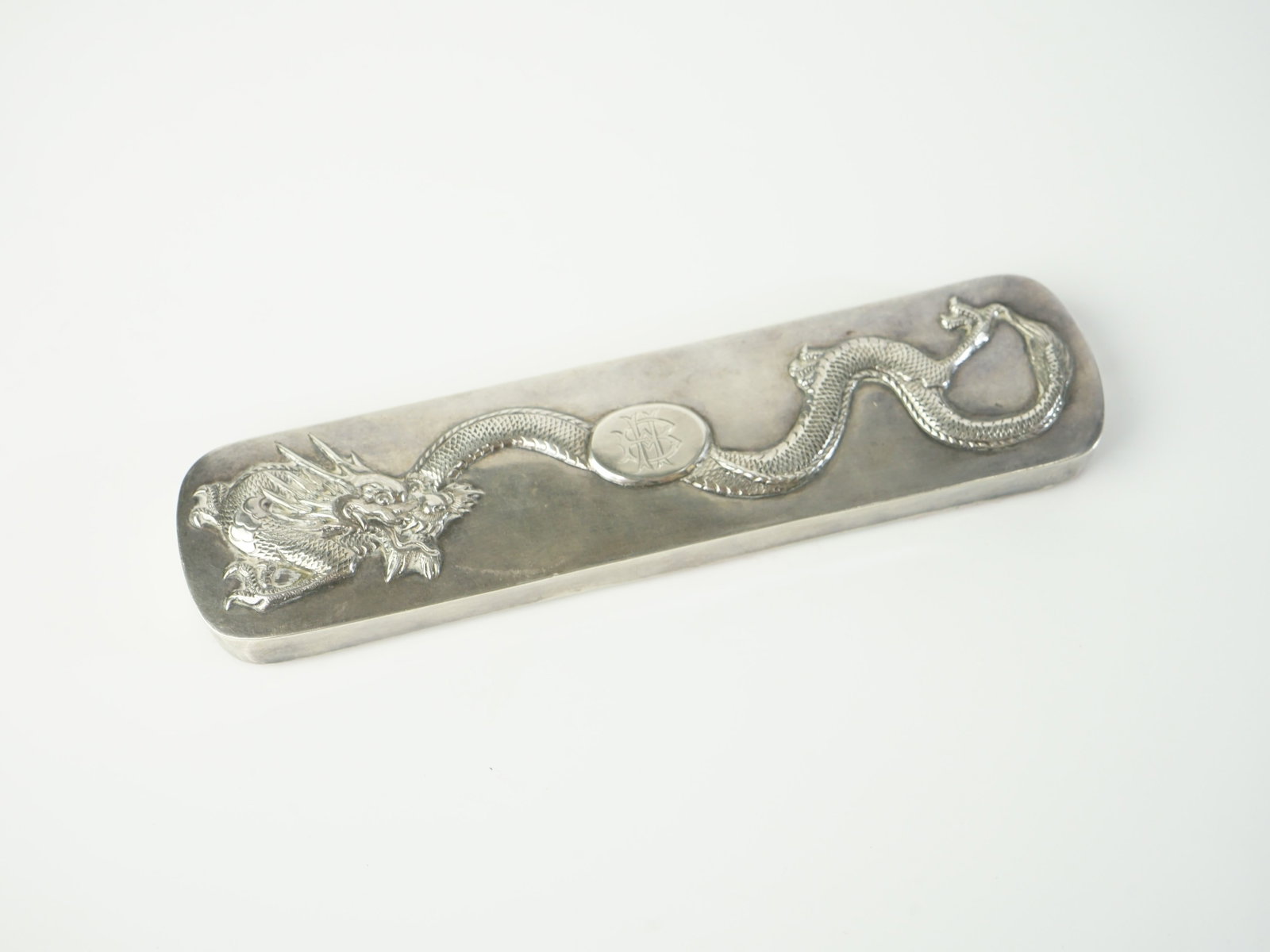 Chinese Export Silver Dragon-Decorated Weighted Paperweight: Approximate size: 7x1 5/8x1/2 in Shipping: We offer in-house shipping services for most small items. This means that we will take care of packing and shipping the items directly to you. For larger or 