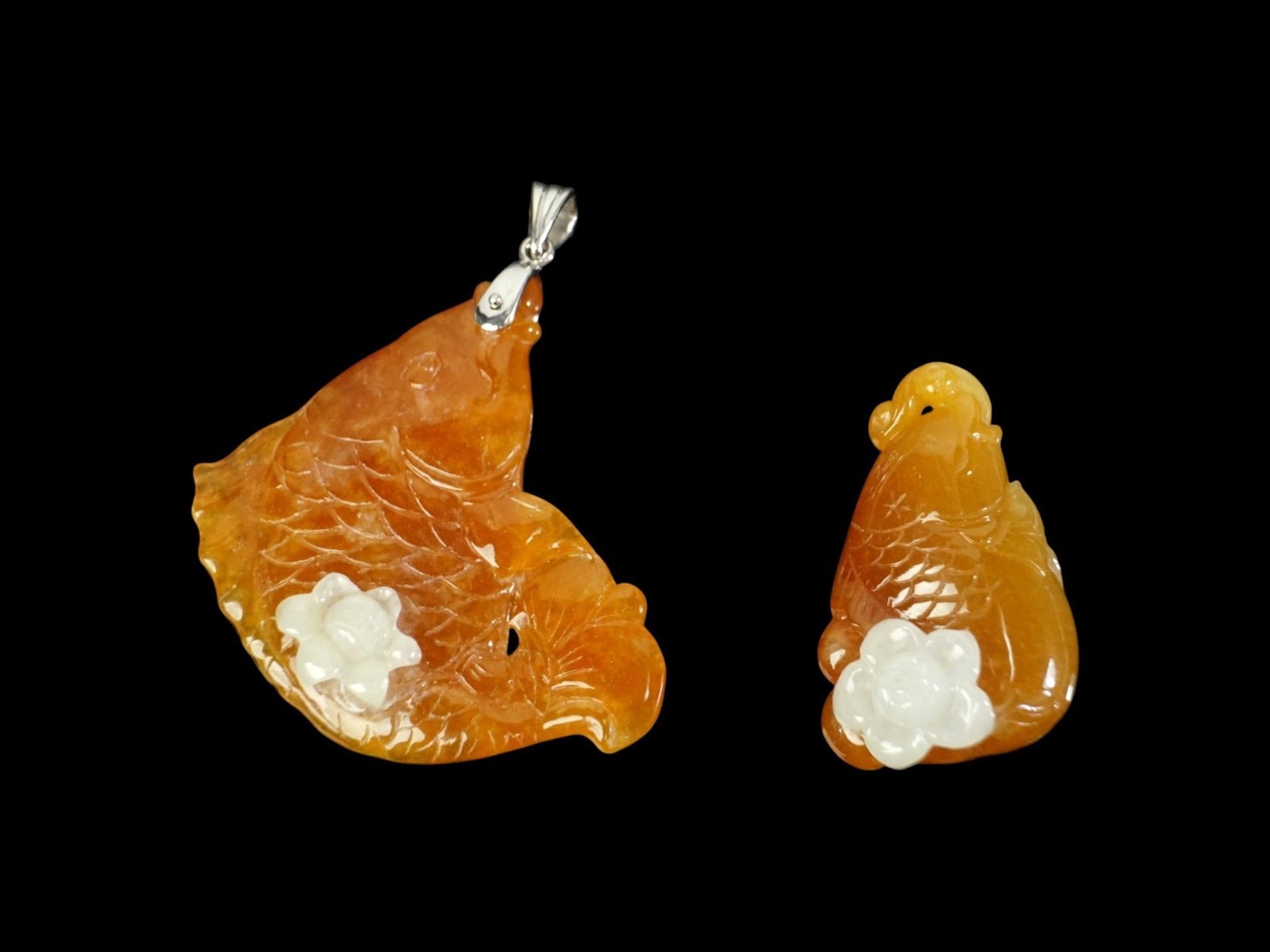 Two Chinese Yellow Jadeite Carp-Form Pendants with 14K White Gold Fitting: Approximate size: larger pendant 2x1 3/8 in,overall weight 95 ct. Shipping: We offer in-house shipping services for most small items. This means that we will take care of packing and shipping the item