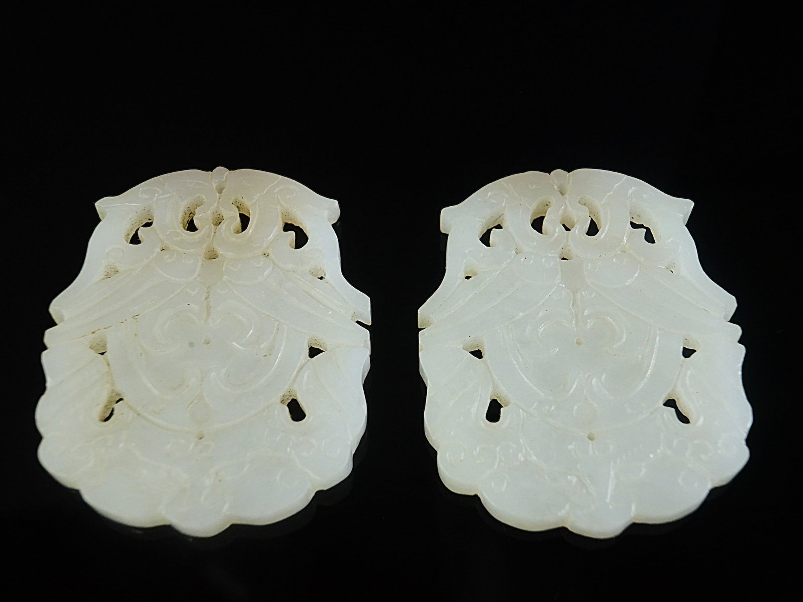 Pair of Chinese Carved White Jade Pendants: Approximate size:2.25x2 in (each). Shipping: We offer in-house shipping services for most small items. This means that we will take care of packing and shipping the items directly to you. For larger o