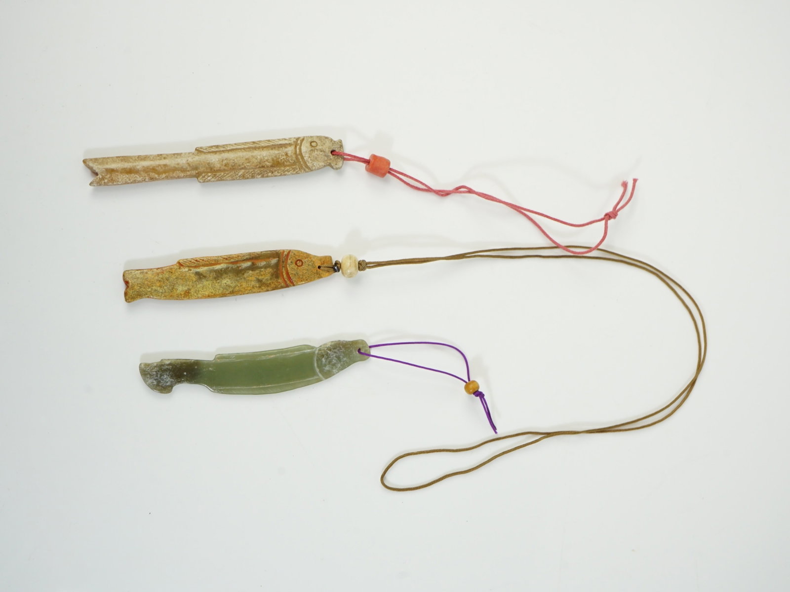 Lot of 3 Archaic Jade Fish Form Pendants: Approximate size: L:3 7/8 in,3 1/8 in,3 1/2 in. Shipping: We offer in-house shipping services for most small items. This means that we will take care of packing and shipping the items directly to you.