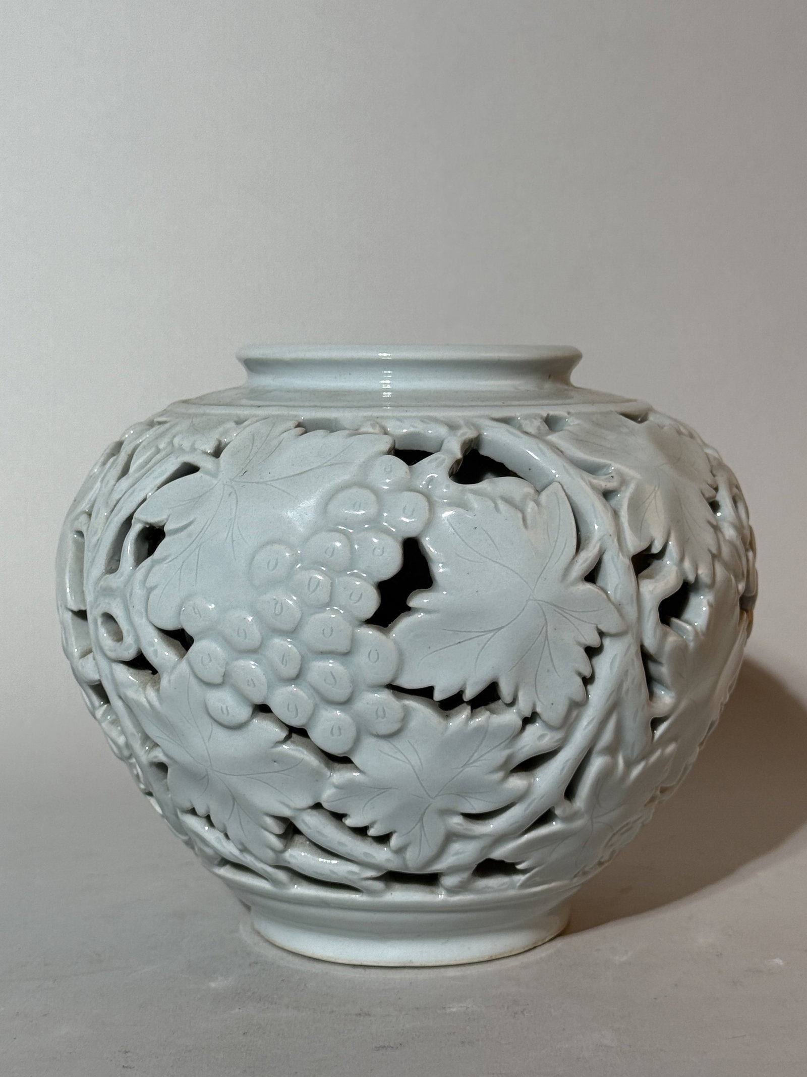 A Korean Double-Walled 'Grape Vine' Porcelain Vase: 6.5"ht 8"wide Shipping: We offer in-house shipping services for most small items. This means that we will take care of packing and shipping the items directly to you. For larger or specialized items, 