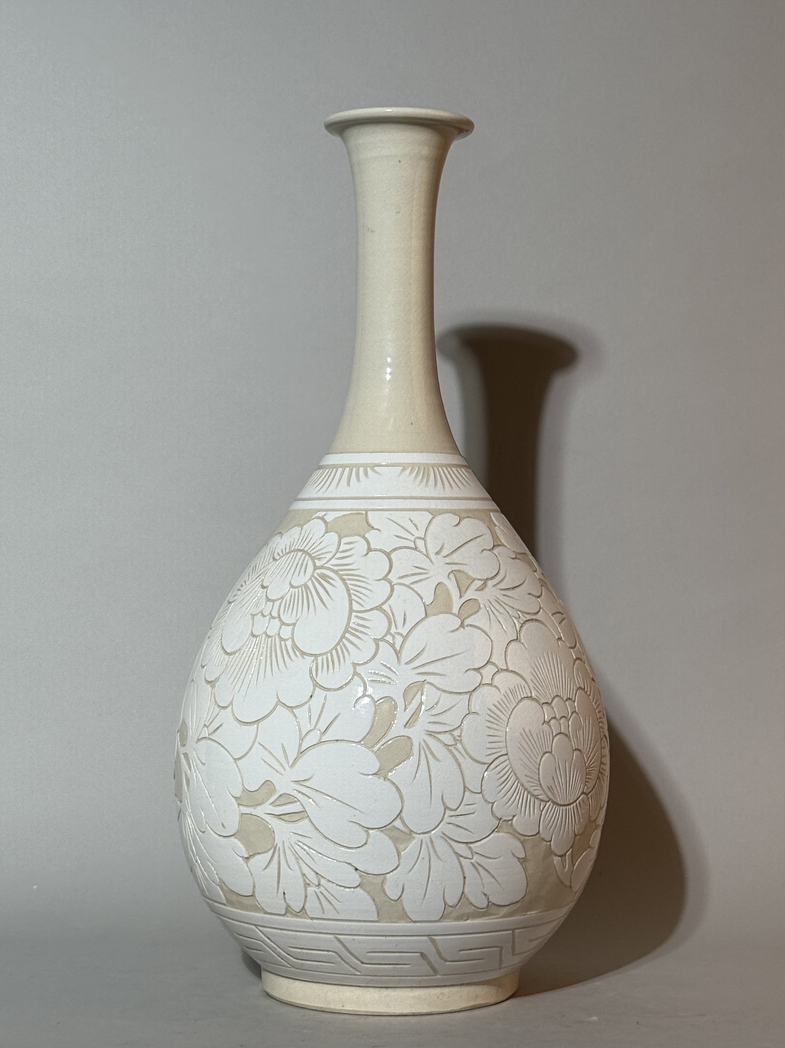 A Japanese Studio Porcelain Vase Carved with Peonies: 17.5"ht Shipping: We offer in-house shipping services for most small items. This means that we will take care of packing and shipping the items directly to you. For larger or specialized items, we