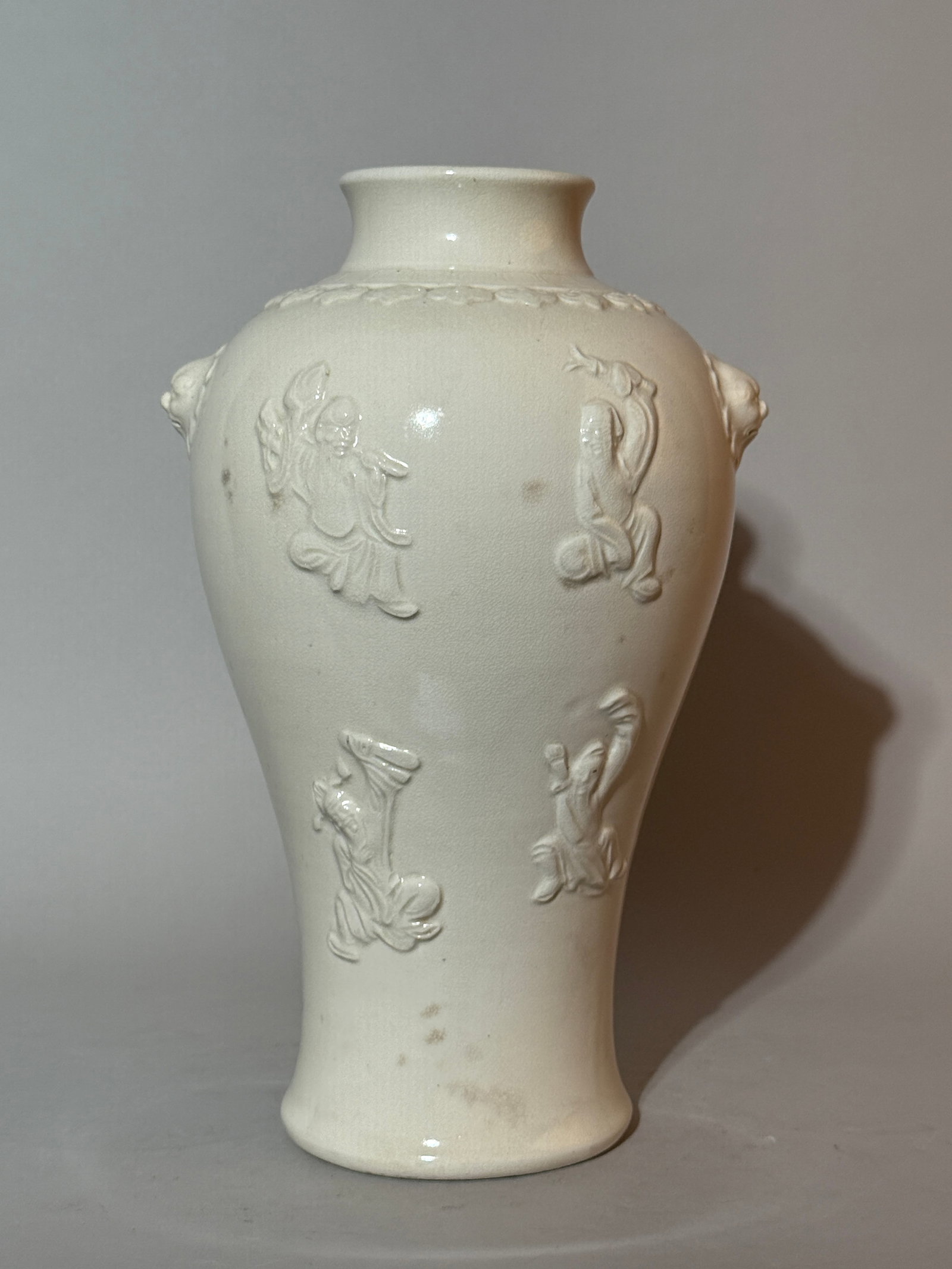 A Chinese White-Glazed Relief-Decorated 'Immortal' Vase: 12"ht, raised immortal design, fired in kiln for lamp design, hole at bottom is glazed on edge Shipping: We offer in-house shipping services for most small items. This means that we will take care of 