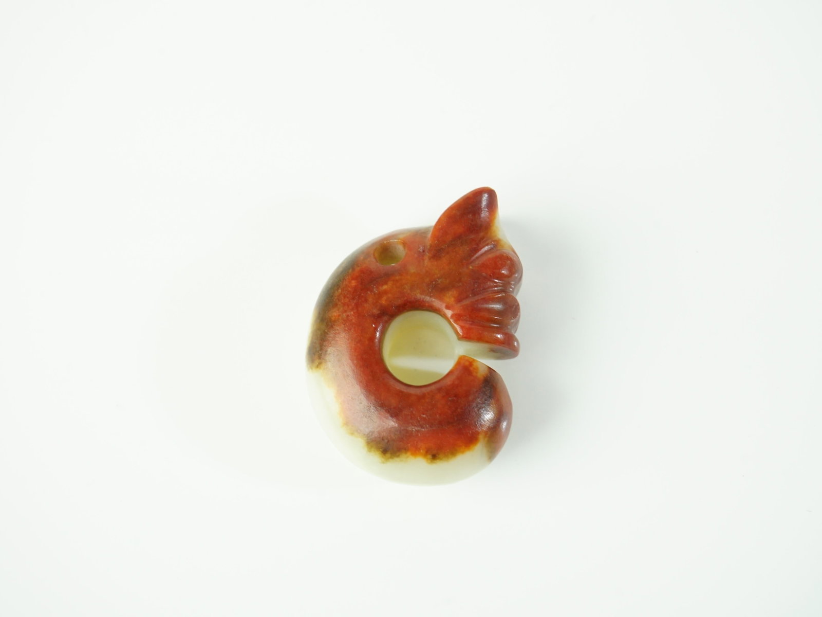 Chinese Neolithic Carved Green and Russet Jade 'Pig-Dragon' Carving: Approximate size: 2.5x1.75x1 in Shipping: We offer in-house shipping services for most small items. This means that we will take care of packing and shipping the items directly to you. For larger or