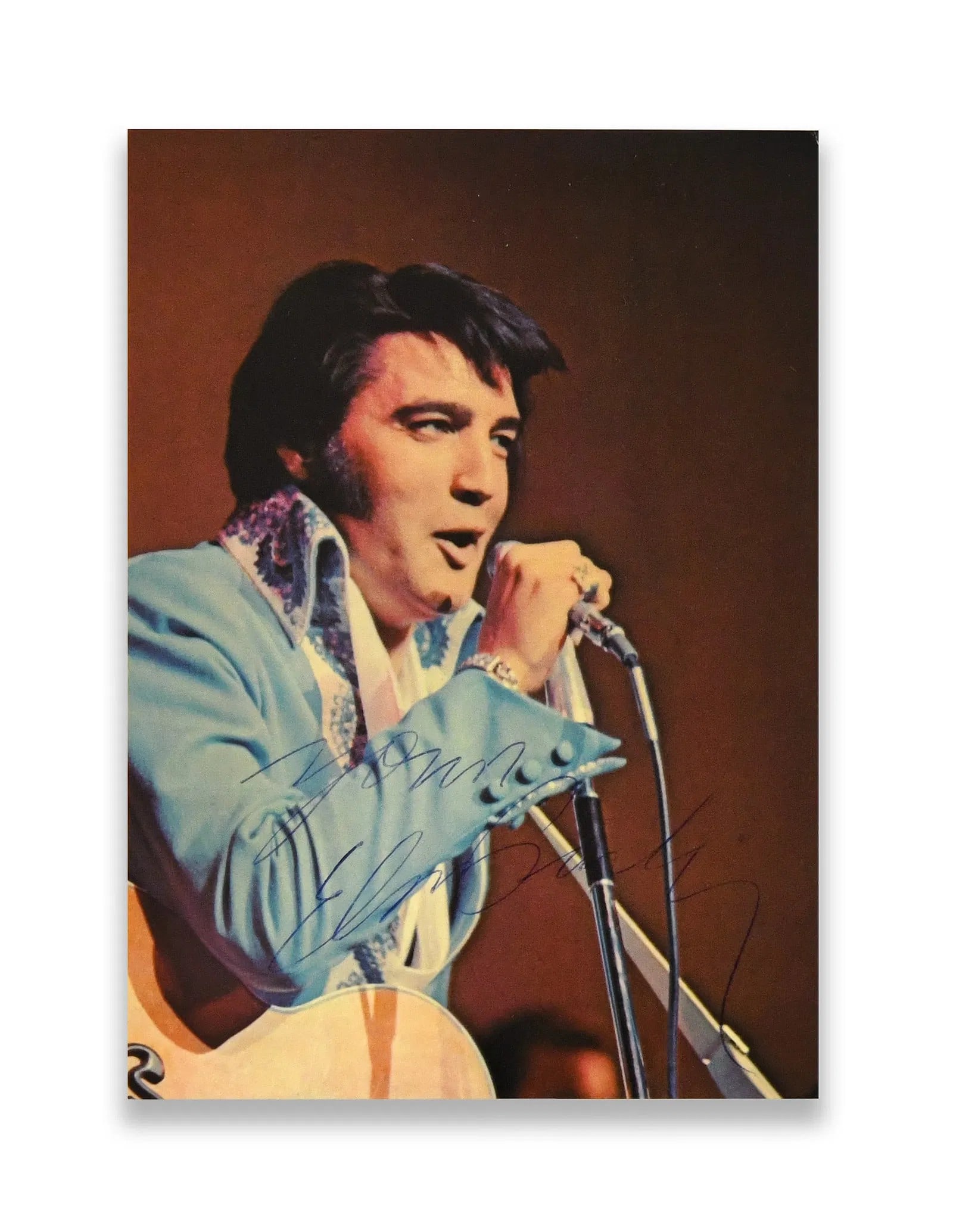 Elvis Presley-Signed Concert Postcard Photograph (C. 1970s): ELVIS PRESLEY - SIGNED CONCERT POSTCARD PHOTOGRAPH (C. 1970S) Provenance and Authenticity: The postcard bears a large, flowing autograph in blue ink across the image field, consistent with Elvis Presl