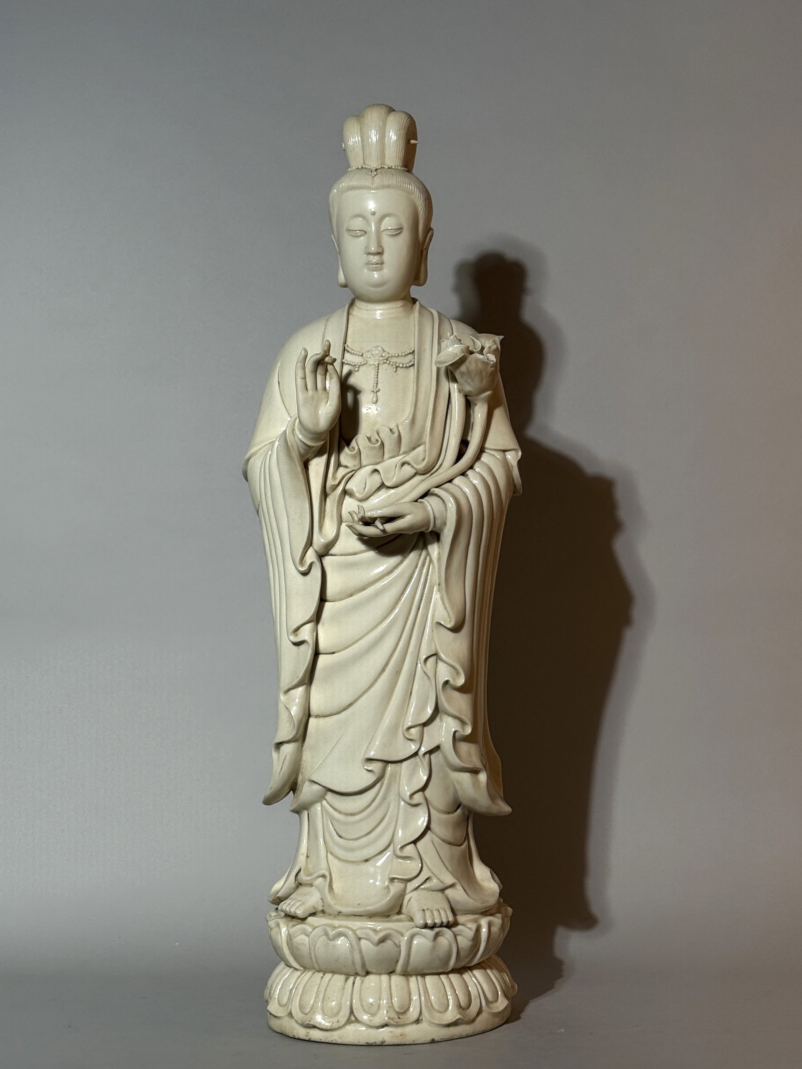 A Tall Chinese Blanc-De-Chine Figure of Guanyin: 26.5"ht, chip onb the lotus flower, impressed maker mark at back Shipping: We offer in-house shipping services for most small items. This means that we will take care of packing and shipping the items