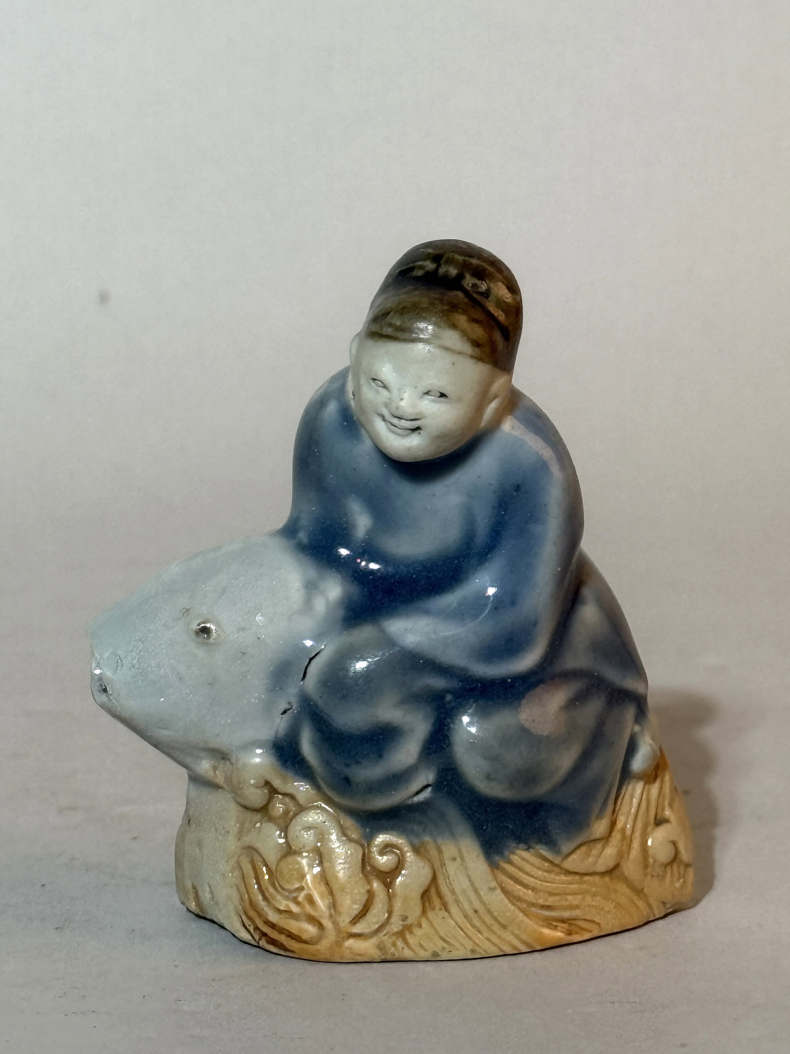 A Chinese Porcelain Scholar's Water Dropper, 18th Century: Scholar riding carp porcelain water dropper, 3"ht, 18th cen Shipping: We offer in-house shipping services for most small items. This means that we will take care of packing and shipping the items