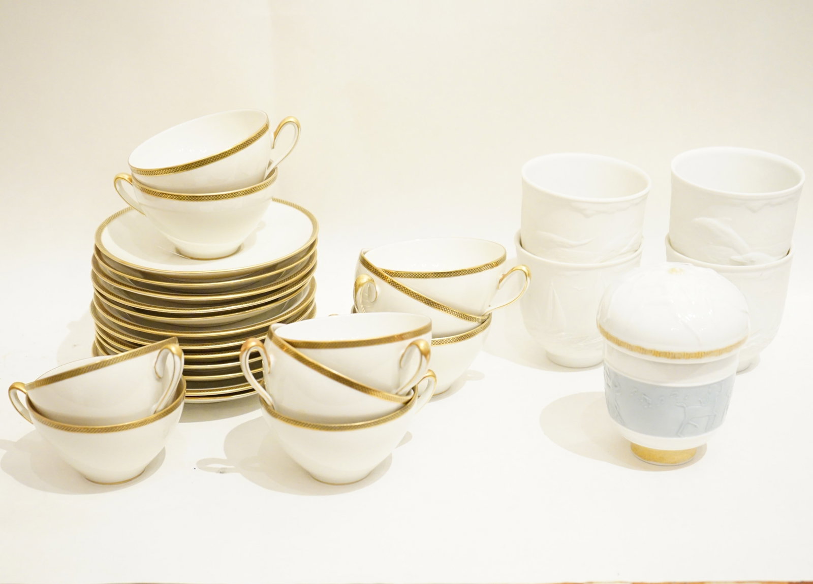 Group of Rosenthal Gold-Trim Porcelain Cups and Saucers with Lladro Porcelain Wares: Approximate size: saucers dia 6 in ,lladro cup H: 4 in. Shipping: We offer in-house shipping services for most small items. This means that we will take care of packing and shipping the items