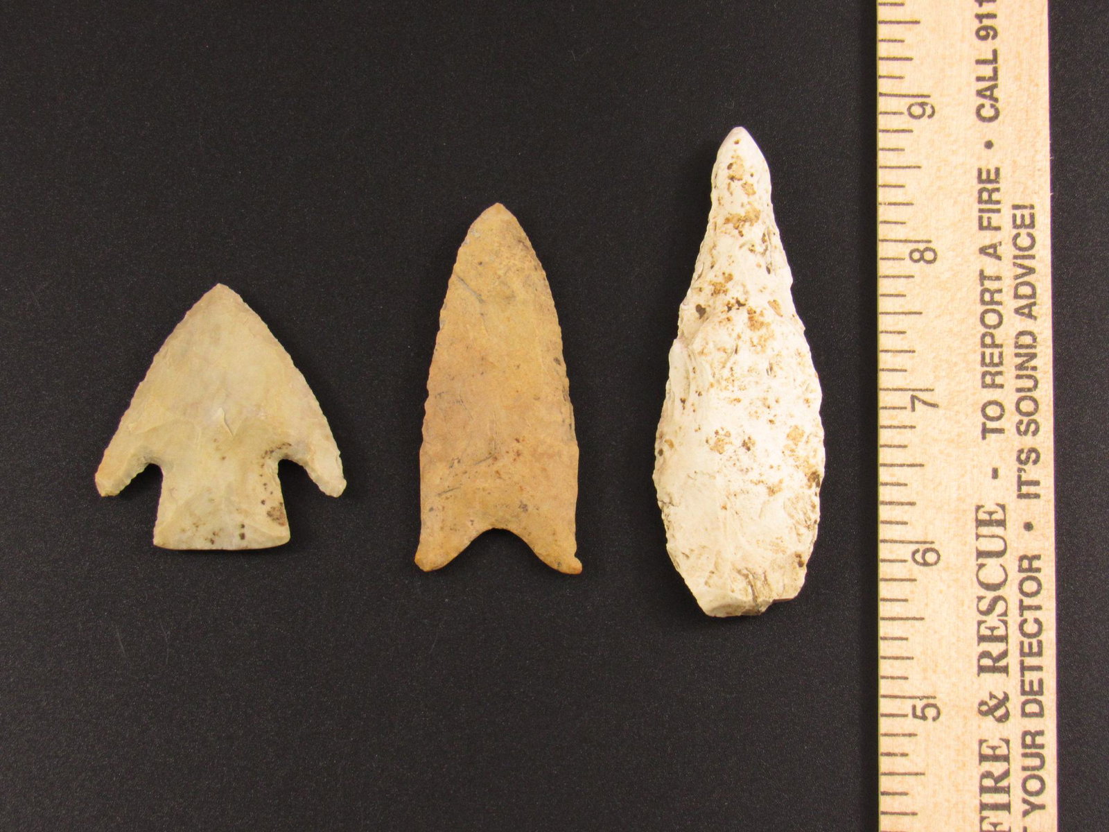 Three Native American Indian Arrowheads: Three Native American Indian flint arrowheads from an old estate in Indiana. These arrowheads are sold as repaired and/or reworked. Some may have glue residue on one side from being attached to a disp