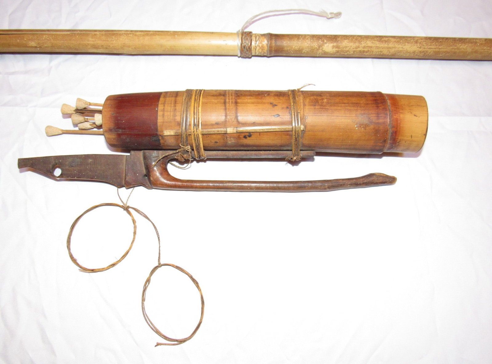Vintage South American Blow Gun With Darts and Wooden Quiver: Nice vintage South American blow gun with darts and wooden quiver. The blow gun tube shows some damage but still displays well (see photos for additional detail). The blowgun tube is approximately 54"
