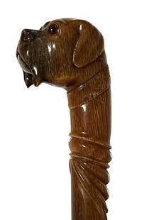 Walking cane with dogs head on top: This waking cane has the head of a dog on top. It is very delicately hand crafted with a recognisable expression of a Boxer. The top of the cane is made of Rhino horn and its estimated to be a 100