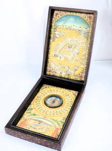 An Islamic compass and Qibla indicator: This rectangular wooden box holds a Compass with Qibla indicator. The outside is decorated with painted, gilded decorations of abstract botanical forms. On the inside of the lid there is a wonderful c