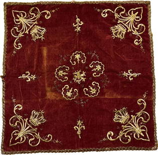 A red Ottoman embroidery: A red velvet square, with gold embroidery on a red background. The decorations are elegant botanical forms, in the corners toped with a crown with a crescent moon on top. Period: early 19th century