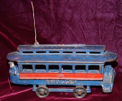 Harris Toy Co. Toledo Trolley Car Toy 2 conductors: Here is a cast iron toy that we were not able to identify with 100% certainty. We believe it to possible be a Dent Hardware Co. toy made around the turn of the 20th century circa 1900-1920. The castin