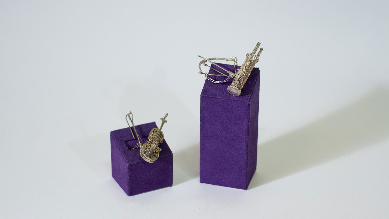 Antique Sterling Silver Filigree Violin and Bow & Arrows Brooch: Antique Sterling Silver Filigree Violin and Bow & Arrows Brooch. Violin measure approx. 2 1/4"L X 5/8" W. Bow measures approx. 1 3/4"L X 1 3/4"W.Cazadora Art Gallery offers complementary free in-house