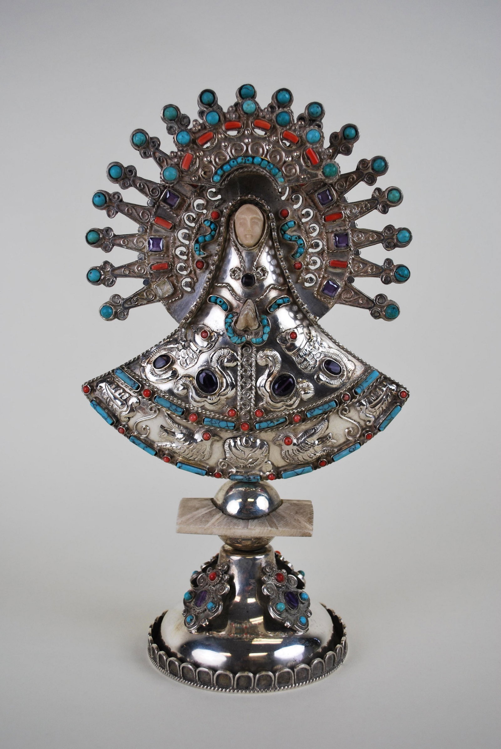 Virgen de Remedios~ Sterling Silver~ Gemstones~ After Matilde Poulat Matl: Virgen de Remedios Sterling Silver, Gemstones (Amethyst, Coral, Turquoise) and Inset Carved Bone. Stamped Sterling Silver, Sanborns 502. Measures 9 3/4" by 6" wide. Approx. weight: 13.25 troy ounces. 